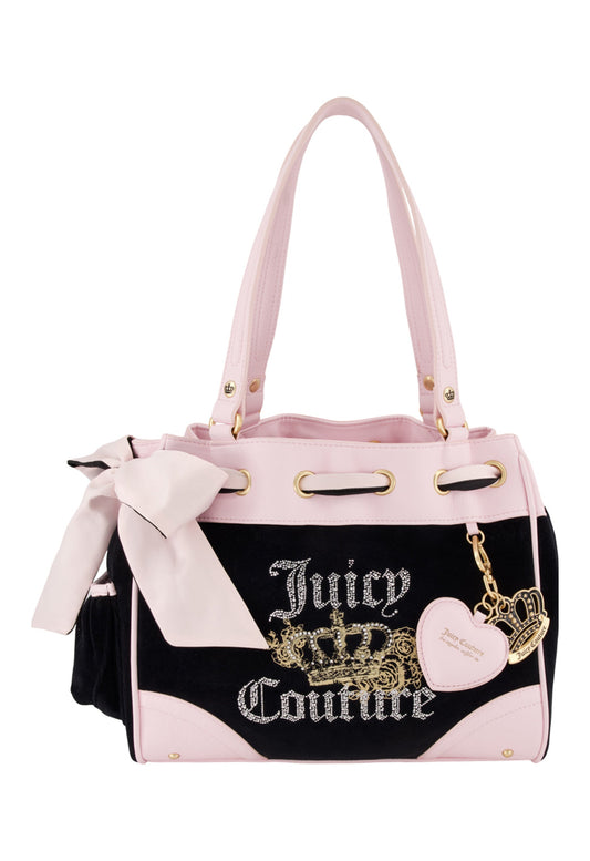 The Royal Bloom Daydreamer Tote Bag features a black and light pink design with gold accents, a bow on one handle, a heart-shaped charm, the Juicy Couture logo, and a gold crown detail on the front.