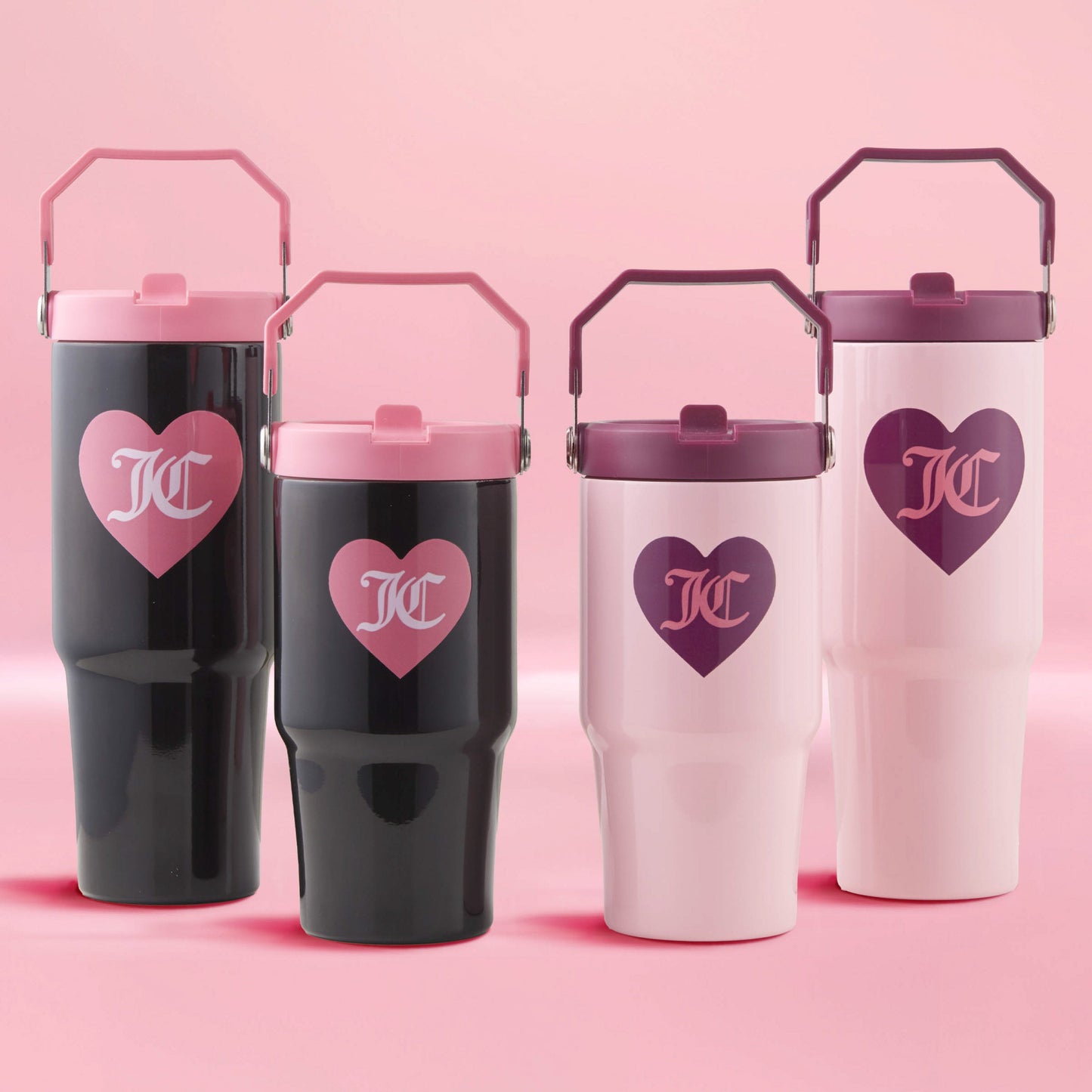 Two Flip Flow Hydration Stainless Steel Tumbler Cup 2-Packs are arranged in a row against a pink background, featuring black and light pink tumblers with heart logos and matching lids.