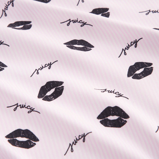 The Printed Microfiber Sheet Set features white fabric with light pink stripes, black lip prints, and “juicy” in cursive—adding playful charm and style to your bedding collection.