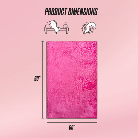 A Plush Oversized Throw Blanket, 60" x 90", in pink with a textured pattern is displayed. Above, illustrations compare the blanket’s ultra-soft size to a sofa and person on a light pink background.
