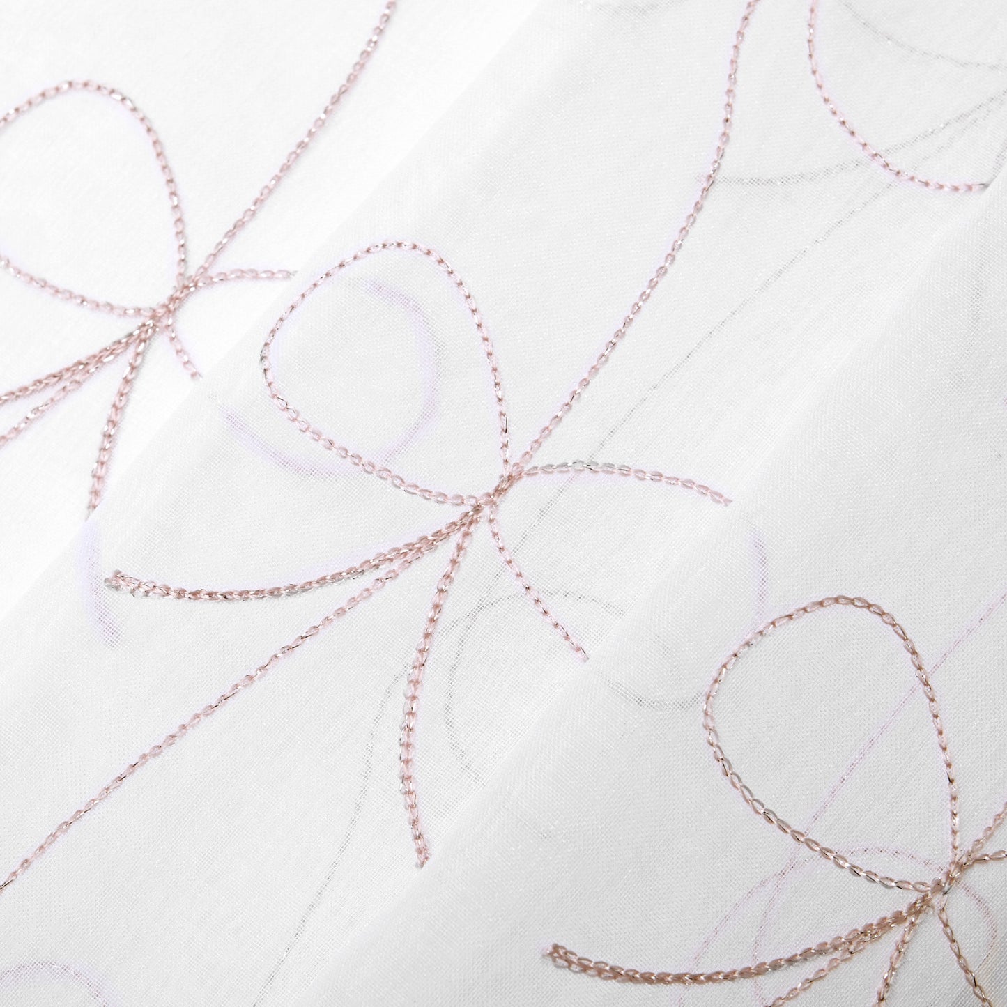 Close-up of the Vertical Bow Ribbon Sheer Window Curtains, showcasing delicate light pink stitched bow patterns on sheer white fabric, creating an elegant and airy look—ideal for adding Juicy Couture-inspired style to your windows or as stylish sheer panels.