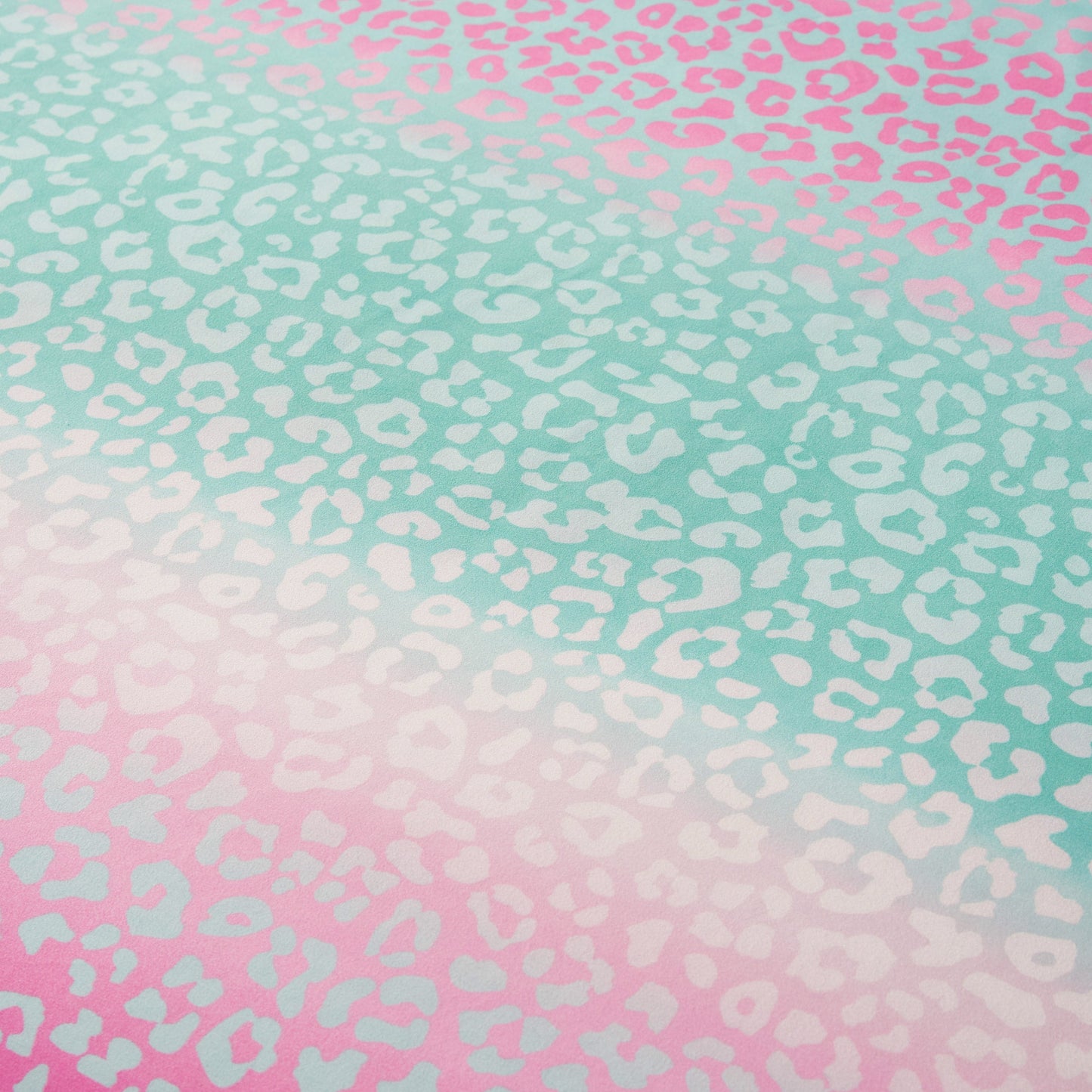Featuring a gradient leopard print with turquoise at the top blending into pink at the bottom, accented by white and light spots throughout, the Kids Rainbow Ombre Leopard Reversible Comforter Set is a vibrant addition to any kid's bedroom.