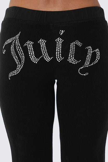 Big Bling Washed Terry Track Pants feature black velour fabric and a sparkling rhinestone Juicy logo across the back, offering bold beach-chic style.