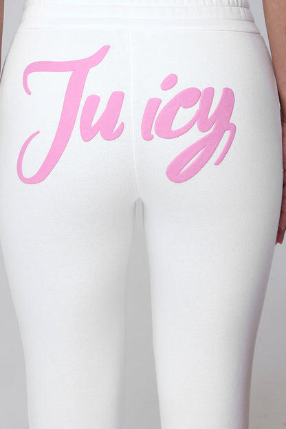 Close-up of a person in relaxed fit Sweetheart Fleece Sweatpants, featuring "Juicy" in bold pink script across the back.