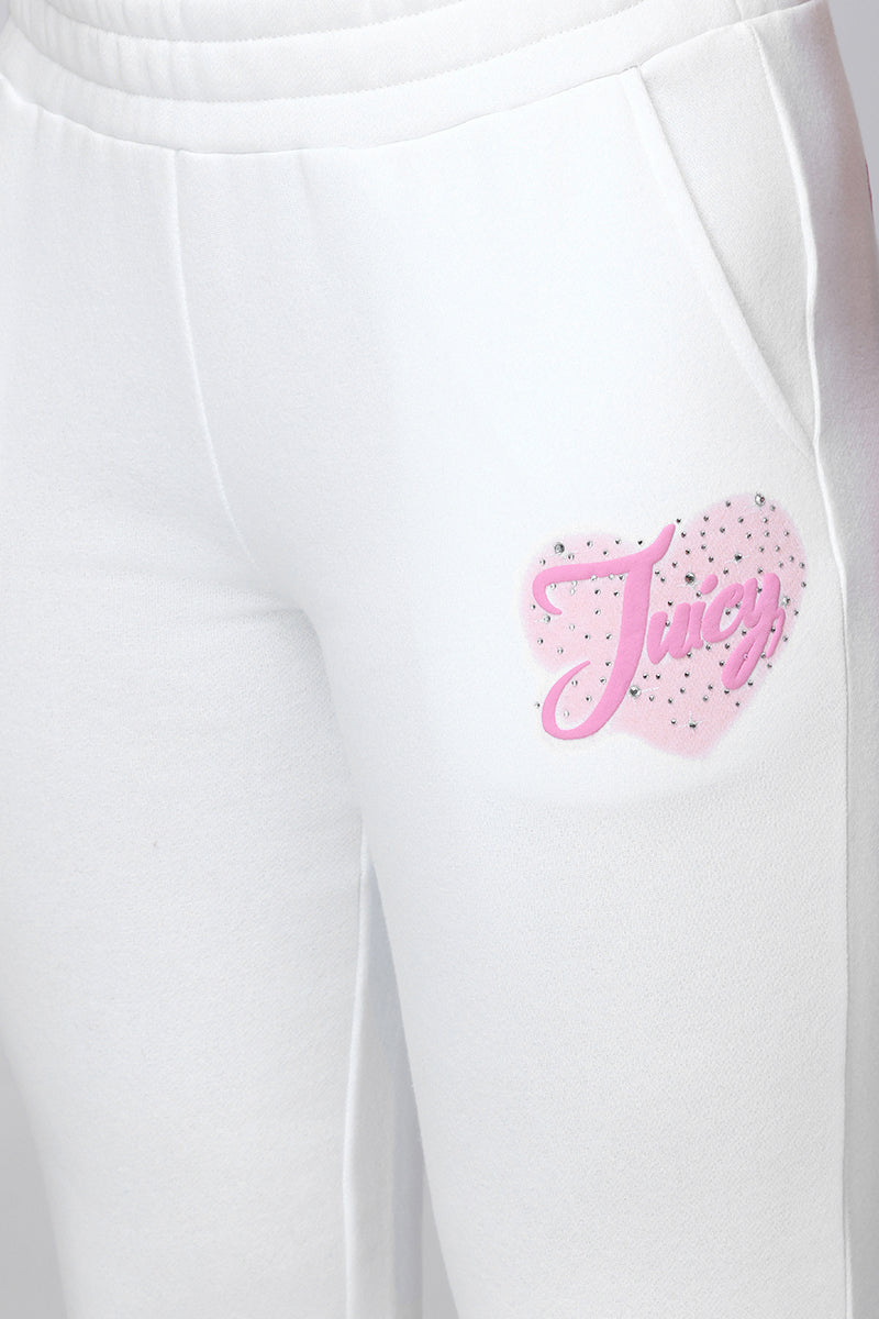 Close-up of the Sweetheart Fleece Sweatpants with pockets, showcasing a pink heart graphic and Juicy in cursive on the left hip—designed for a relaxed fit.