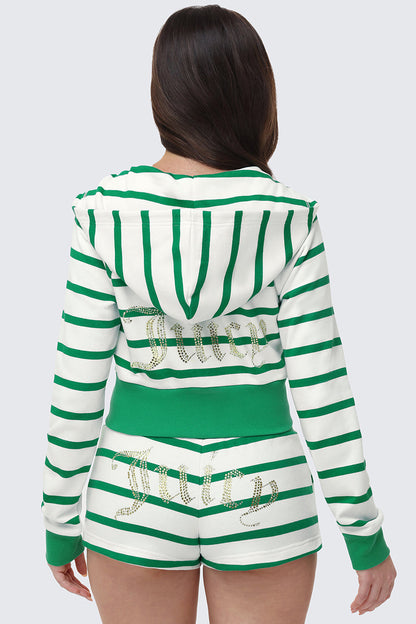 A woman faces away, wearing the Stripe Bling Terry Hoodie and matching shorts in green and white stripes. Both have a cropped fit and gold rhinestone Juicy logo on the back.