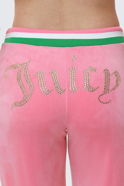 A close-up of the Heritage Stripe Bling Velour Track Pants featuring a green and white striped waistband and the Juicy logo in rhinestones across the back.