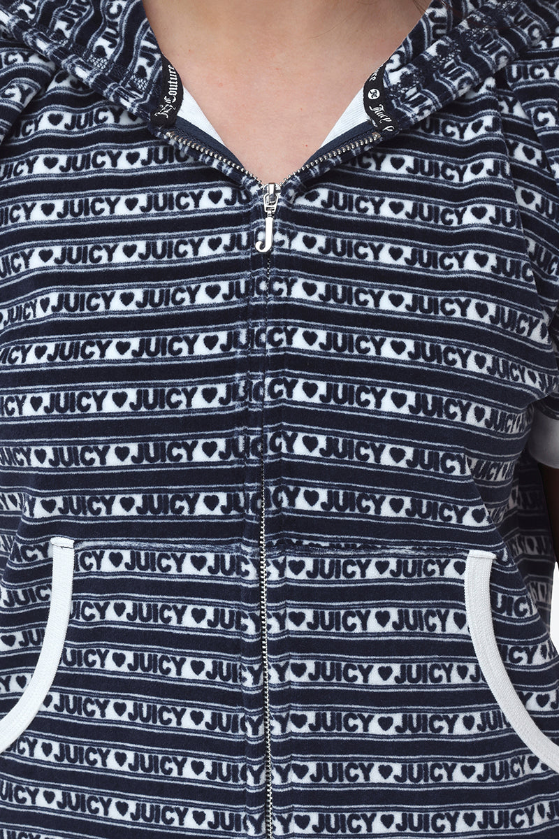 Close-up of the Logo Stripe Short Sleeve Zip Hoodie, a black and white zip-up with Juicy logo stripes and heart patterns in horizontal rows. Two pockets with white trim add sporty style near the bottom.