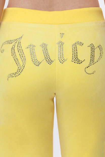 Close-up of OG Big Bling Velour Track Pants in Y2K-inspired yellow, featuring "Juicy" spelled out in rhinestones across the back.