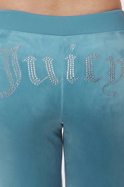 Close-up of the back of OG Big Bling Velour Track Pants in teal, featuring "Juicy" spelled out in silver rhinestones across the waistband for a luxe Y2K vibe.
