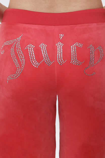A close-up of the back of OG Big Bling Velour Track Pants, featuring "Juicy" spelled out in rhinestones across the seat for a Y2K-inspired look.
