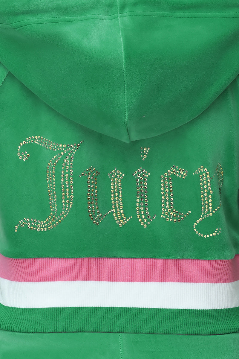 A close-up of the Heritage Stripe Bling Velour Zip Hoodie in green, featuring "Juicy" in rhinestones on the back and a waistband with pink and white stripes.
