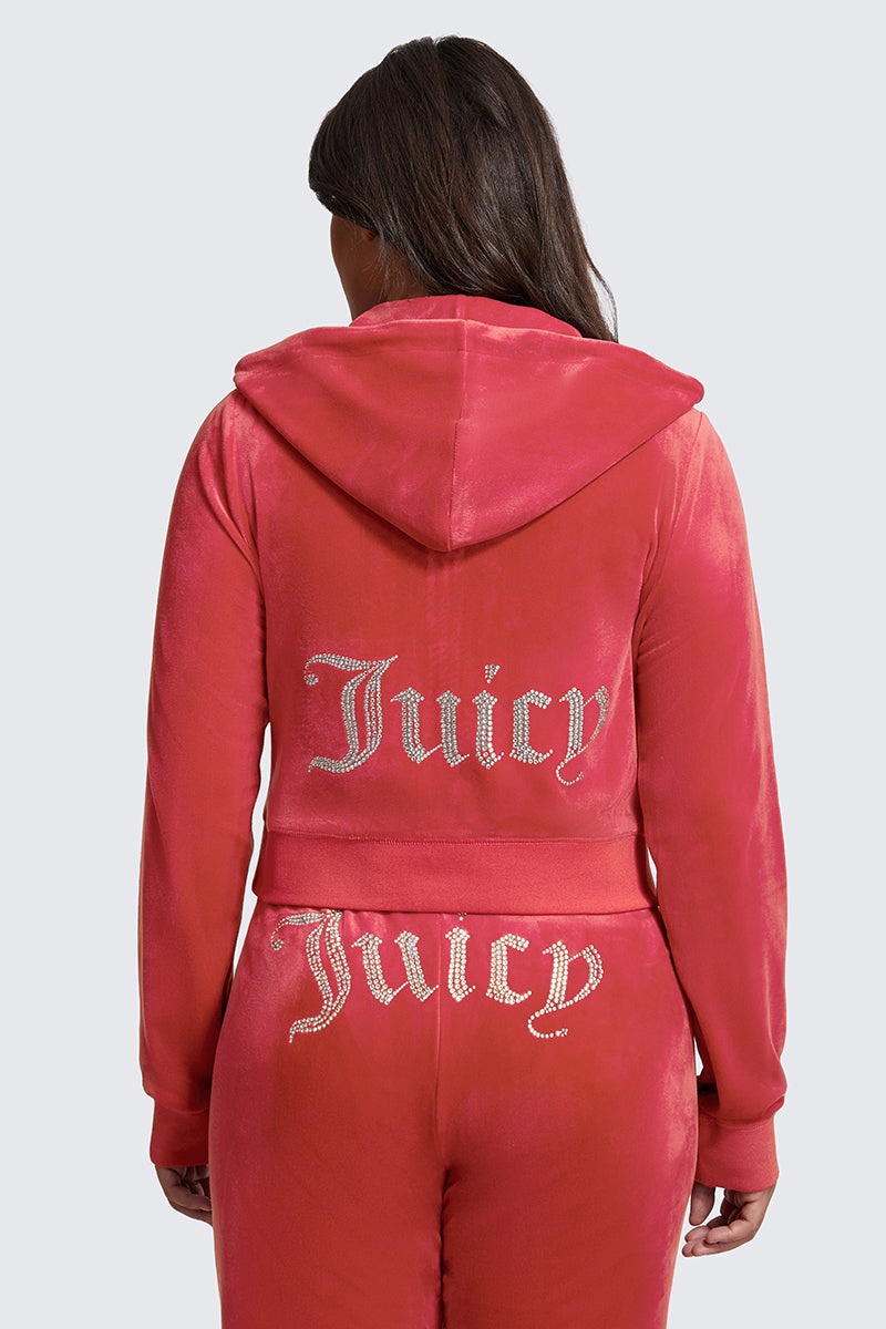 A person is seen from the back wearing the Plus-Size OG Big Bling Velour Hoodie in pink velour, featuring Juicy embellishment in rhinestones, paired with matching pants.