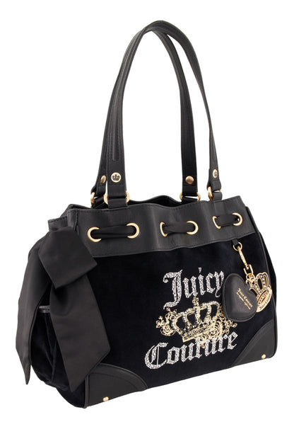 The black Royal Bloom Daydreamer Tote Bag by Juicy Couture features gold accents, a large side bow, an embroidered crown logo, and a gold keychain with heart and crown charms—ideal for adding signature Juicy style to any outfit.