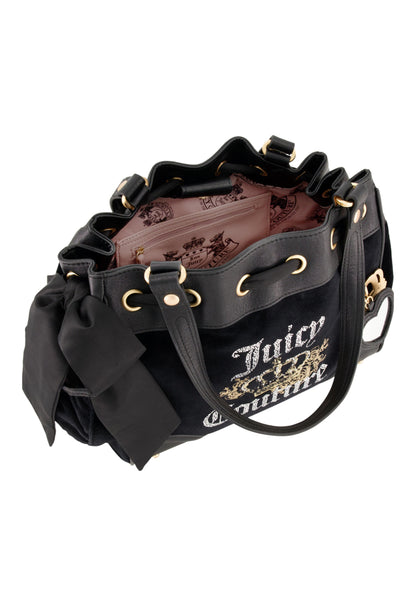 The Royal Bloom Daydreamer Tote Bag is a black Juicy Couture tote with gold accents, a large black side bow, pink patterned interior lining, and rhinestones spelling “Juicy Couture” on the outside.