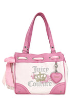 The Royal Bloom Daydreamer Tote Bag by Juicy Couture features pink and white design, double handles, crown logo, silver glitter lettering, a pink side bow, and a heart-shaped keychain—ideal for a glamorous tote collection.