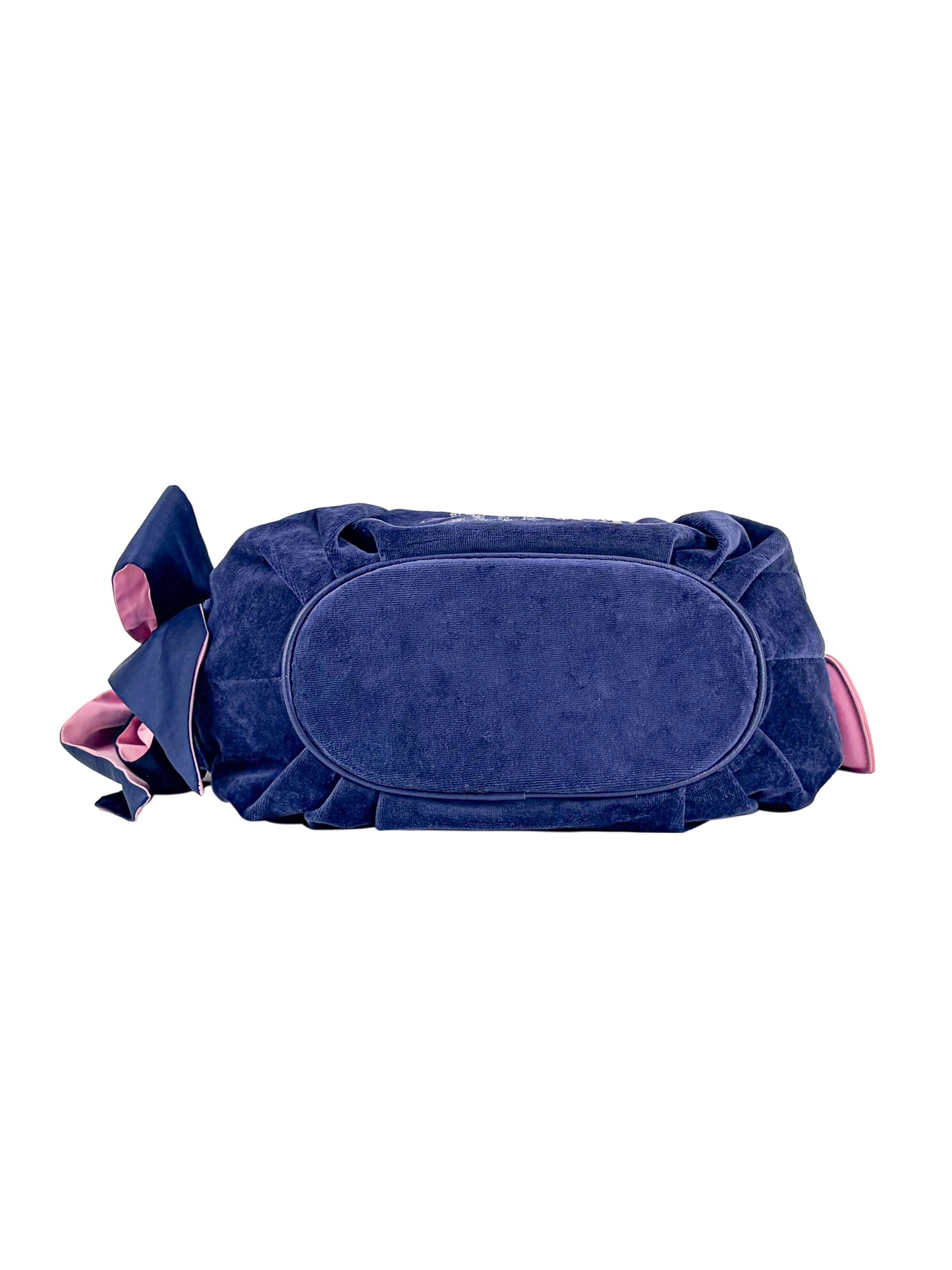 The Royal Bloom Hobo Bag is a feminine navy blue suede bag with pink accents and a large decorative bow, shown from the bottom on a white background.