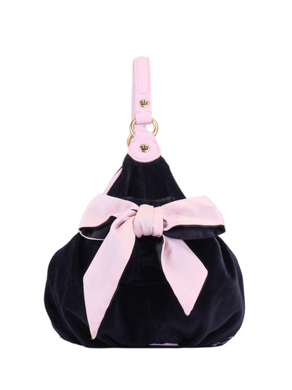 The Royal Bloom Hobo Bag is a black velvet glam bag with a pink leather strap, a bold pink bow on the front, and gold hardware—perfect as your standout everyday accessory.