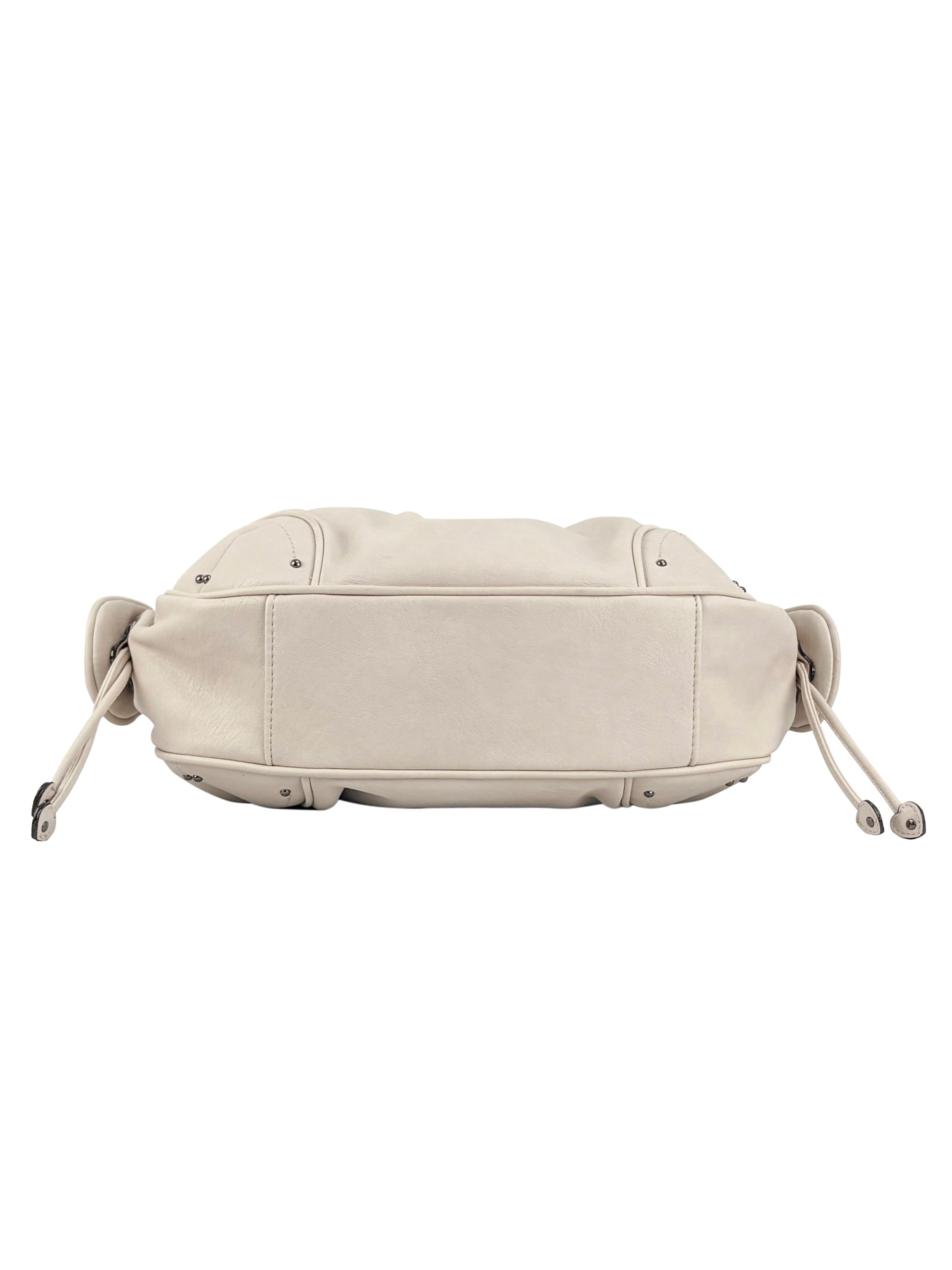 A beige leather Vintage Vibes Satchel Bag shown from the bottom, featuring drawstring details on both sides and visible edge stitching for a touch of throwback glamour.