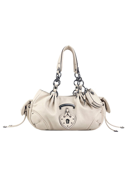 The Vintage Vibes Satchel Bag features cream-colored leather, silver hardware, dual chain-link handles, knot side accents, and a front lock plate for retro-inspired style.