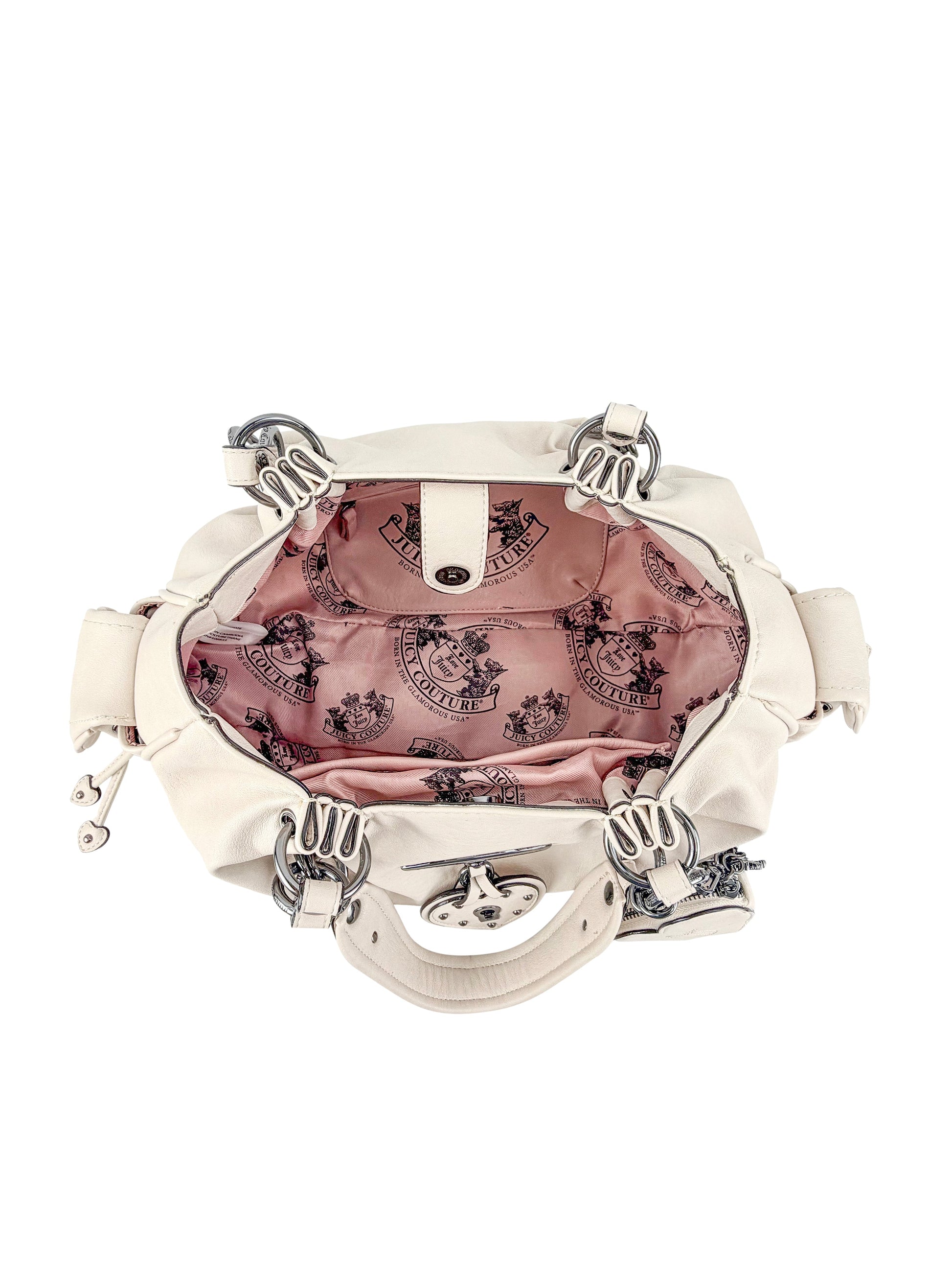The Vintage Vibes Satchel Bag features a cream exterior, silver hardware, and an open view of its pink satin lining with a Juicy logo print—ideal for fans of retro glamour.