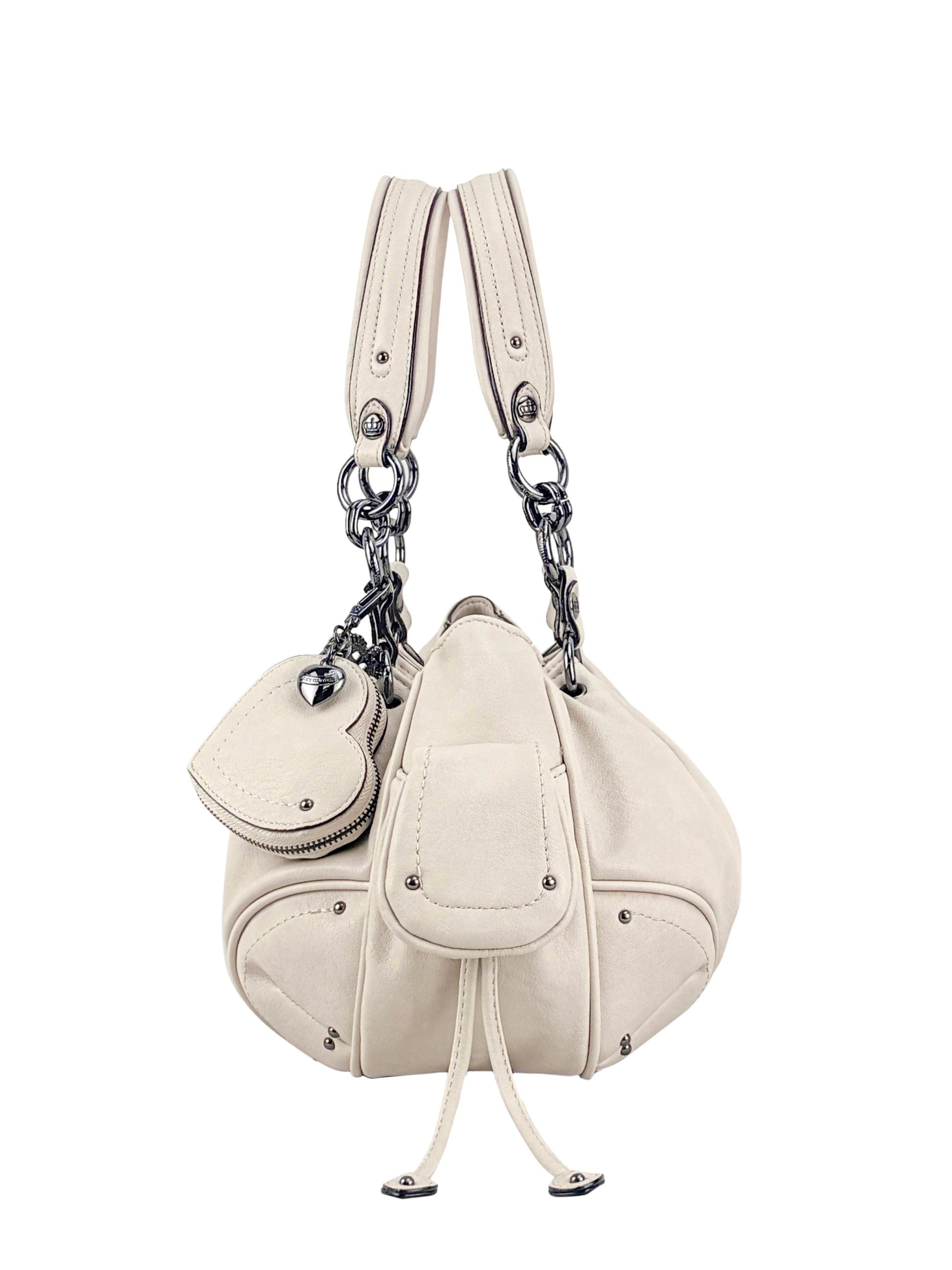 The Vintage Vibes Satchel Bag is cream-colored leather with metal hardware, dual handles, decorative stitching, a front pocket with flap and drawstring, plus a matching coin pouch attached by a chain for retro style.