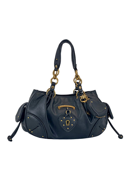 The Vintage Vibes Satchel Bag features black leather, gold hardware, double handles, and a decorative lock and key. Side pockets, studs, and a structured design add a throwback glamour to this Juicy satchel.