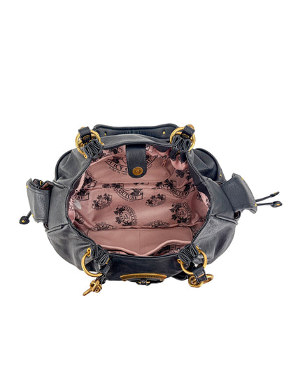 The black leather Vintage Vibes Satchel Bag features gold hardware, a Juicy pink logo-print interior, and multiple side pockets and compartments for added retro glamour.