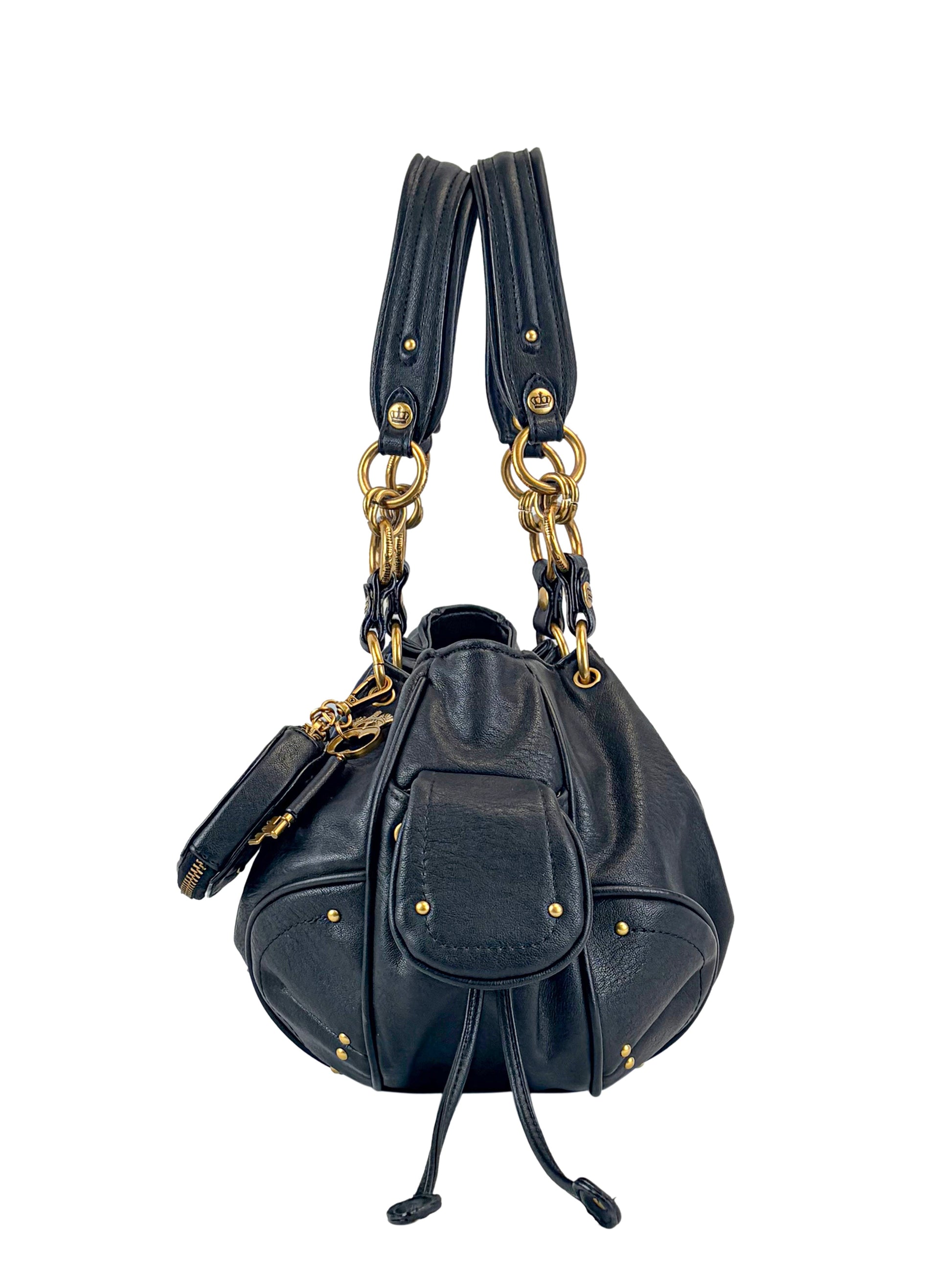 The Vintage Vibes Satchel Bag in black leather features gold hardware, double handles, a front flap pocket, and key pouch, exuding retro glamour in a stunning photo set against a white background.