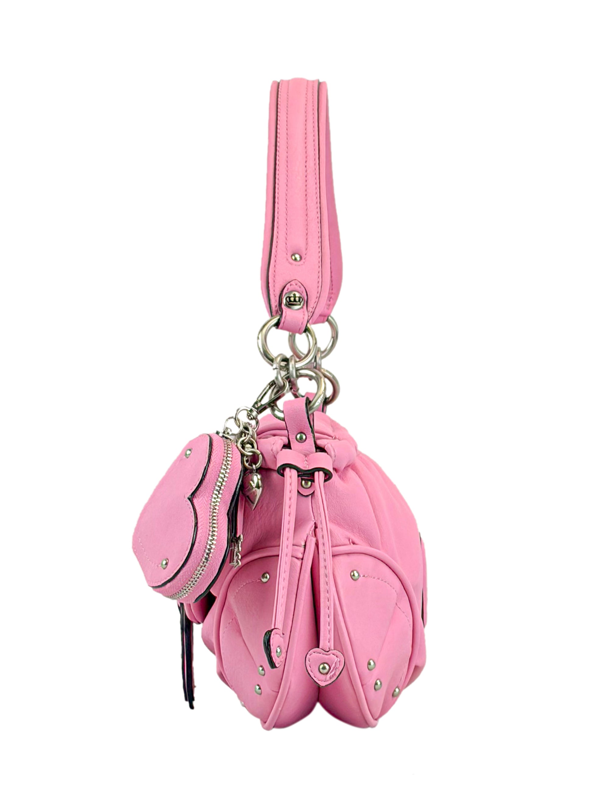 The Vintage Vibes Hobo Bag is a pink handbag with silver studs, a thick handle, and a matching coin purse attached by chain. Its gathered design and metallic hardware give it chic retro style.