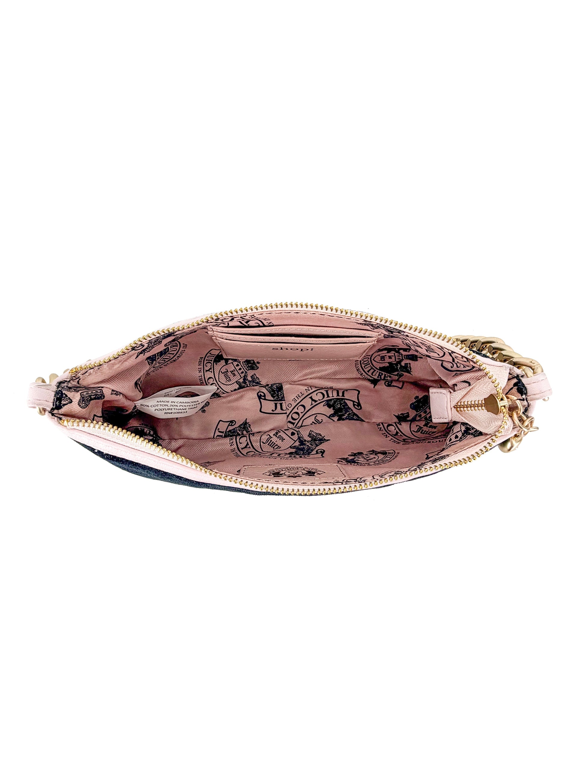 An open Royal Bloom Shoulder Bag from the Timeless Glamour collection reveals a pink fabric lining with black printed illustrations and text inside, viewed from above.