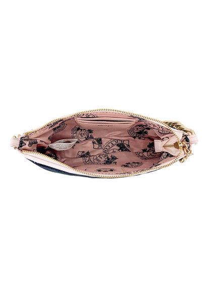 An open Royal Bloom Shoulder Bag from the Timeless Glamour collection reveals a pink fabric lining with black printed illustrations and text inside, viewed from above.