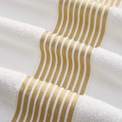 Close-up of the Melissa Bath Towel Set—soft, plush 100% cotton towels accented with horizontal gold wavy stripes for an elegant, visually appealing design.