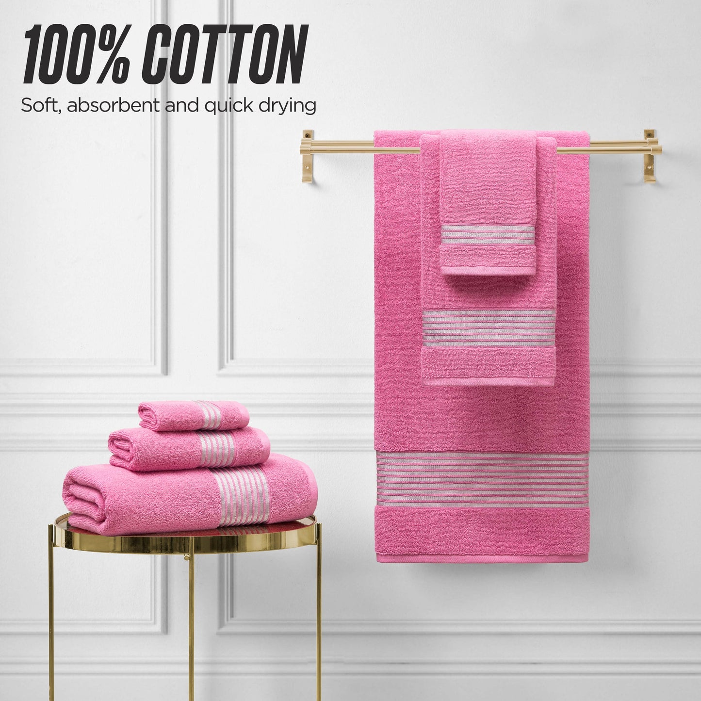 A set of pink Melissa Bath Towel Set with striped accents is displayed—some folded on a round gold table, others hanging on a wall rack. Text reads: 100% cotton, soft, absorbent, and quick drying.