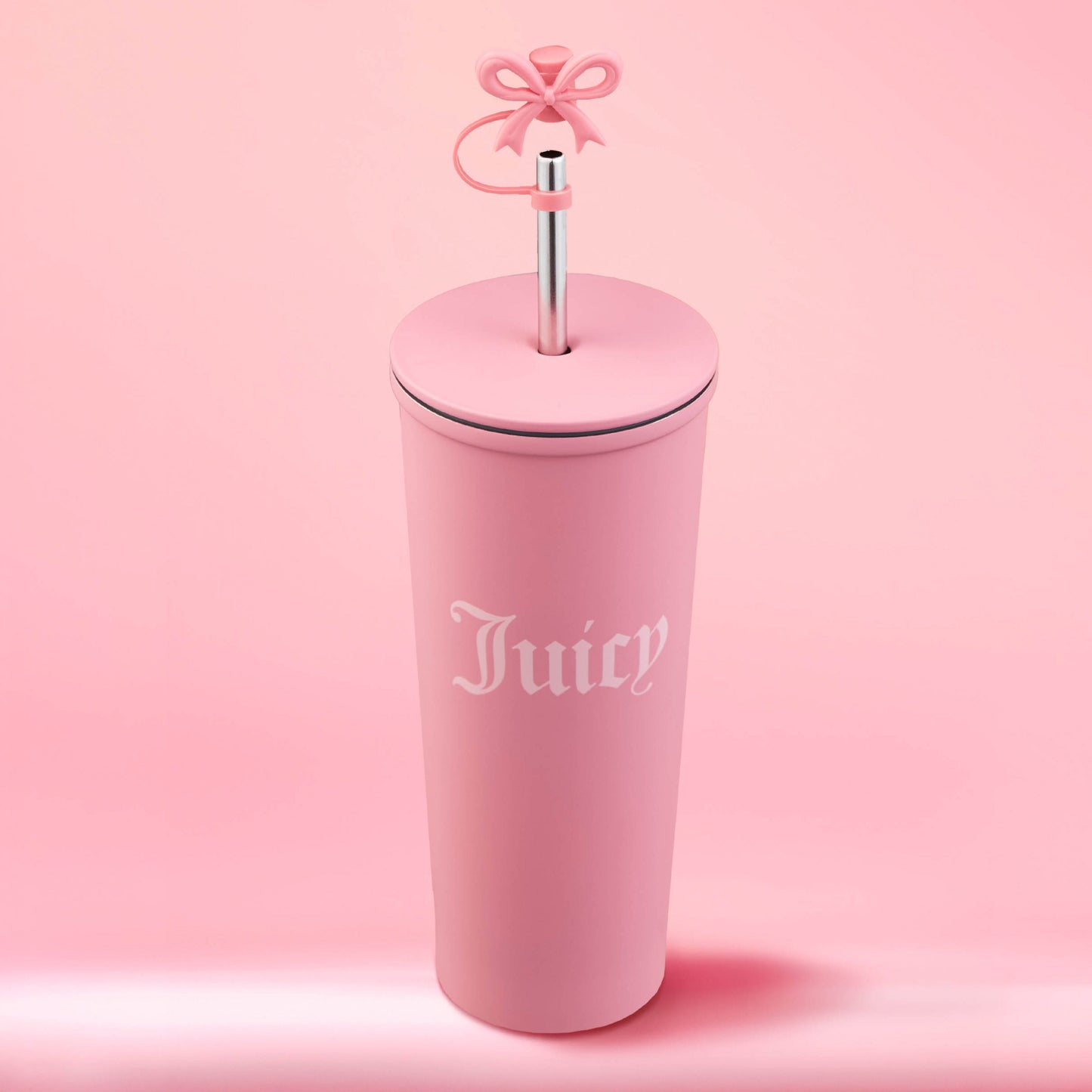 The Couture Hydration Stainless Steel Tumbler Cup 6-Piece Set features tall, matte pink tumblers with “Juicy” in white gothic font, metal straws, and pink bows—perfect for gifting and displayed against a soft pink backdrop.