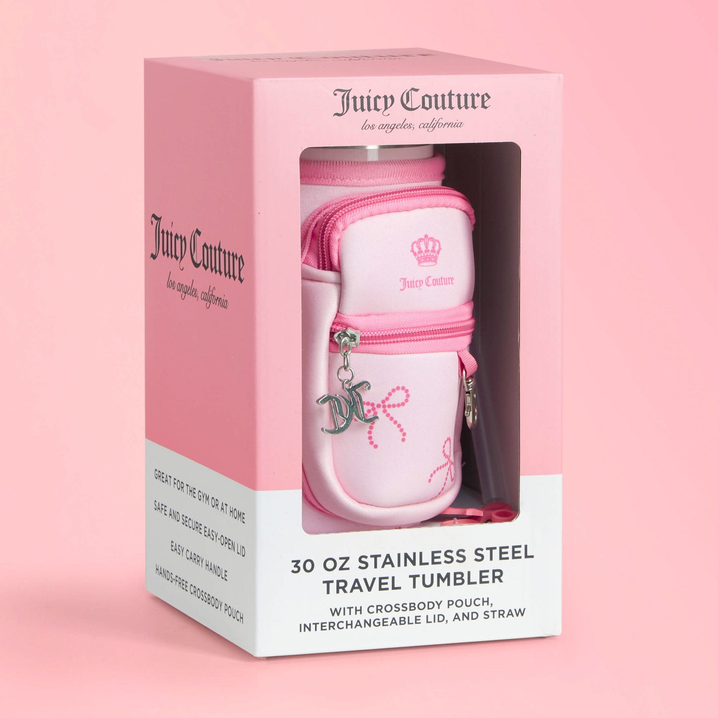 The Jetsetter Hydration Stainless Steel Tumbler, 30 oz, in pink comes with a chic neoprene crossbody pouch, interchangeable lid, straw, and signature Juicy Couture branding. Packaged in a stylish pink and white box.