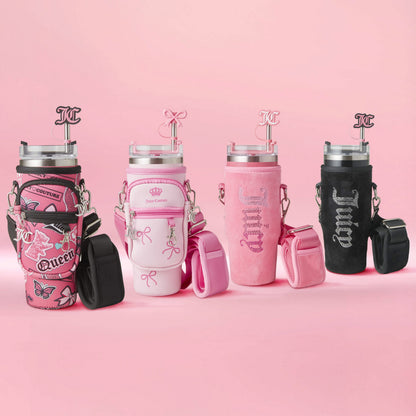 Four Jetsetter Hydration Stainless Steel Tumblers with neoprene crossbody pouches, each featuring unique pink-themed patterns and text, decorative straps, and straw toppers, are displayed against a soft pink background.