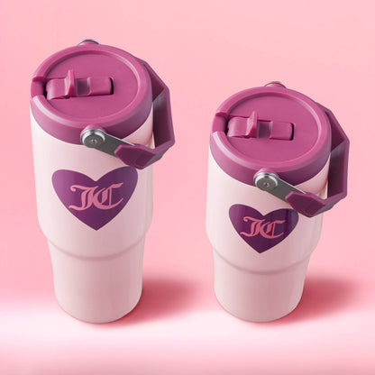 Two pink Flip Flow Hydration Stainless Steel Tumbler Cups with purple lids and handles are shown against a pink background. Each insulated tumbler features a heart-shaped logo, making them the perfect mommy and me gift set.