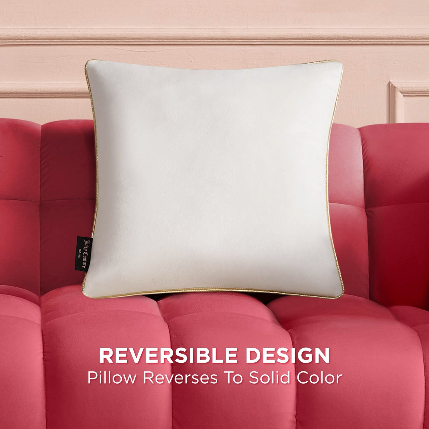 The Velvet Cheetah Pillow with gold piping rests on a red tufted sofa. A black side tag is visible. Text below reads: Reversible Design—this decorative pillow reverses to a solid color.