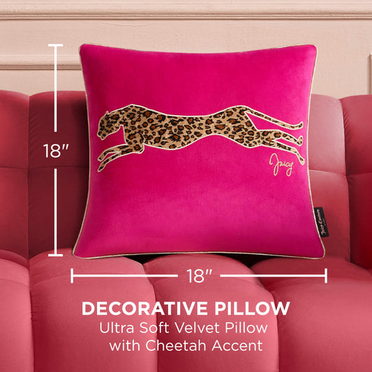 The Velvet Cheetah Square Pillow, in hot pink velvet with a leaping cheetah applique and Juicy Couture signature accent, measures 18"x18" and sits on a matching tufted sofa.
