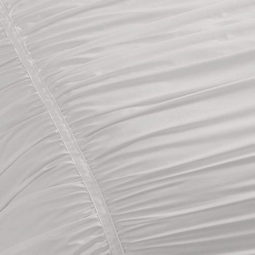 Close-up of the Ribbon Ruched Comforter Set in white, featuring gathered pleats, ribbon detailing, and a vertical seam for added texture and elegance.