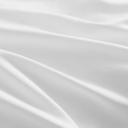 Close-up of the Ribbon Ruched Comforter Set, featuring white, smooth fabric with gentle folds and curves that create a calm and elegant texture.