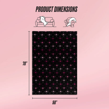 The Plush Throw Blanket by Juicy Couture features a black pattern with pink and white accents. Shown with dimension lines of 70x50 inches, icons above display the ultra-soft blanket on a sofa and around a person, labeled as Product Dimensions.