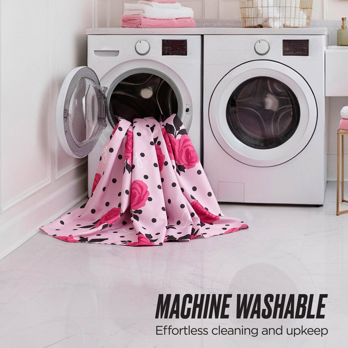 A chic Juicy Couture Shower Curtain and Hooks Set is draped near a modern washer and dryer, with a pink and black blanket nearby. Text reads: MACHINE WASHABLE: Effortless cleaning and upkeep.