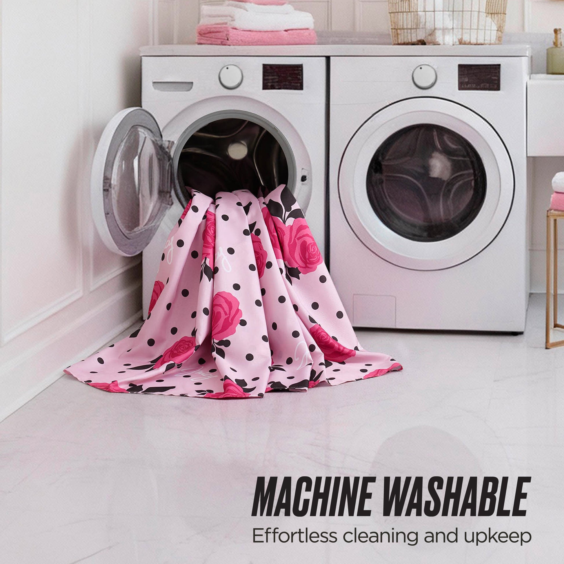 A chic Juicy Couture Shower Curtain and Hooks Set is draped near a modern washer and dryer, with a pink and black blanket nearby. Text reads: MACHINE WASHABLE: Effortless cleaning and upkeep.