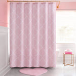 A pink bathroom with a Shower Curtain and Hooks Set featuring a subtle white pattern, a pink heart-shaped bath mat, a white tub, neatly folded pink and white towels on a gold stand, and large windows letting in natural light.