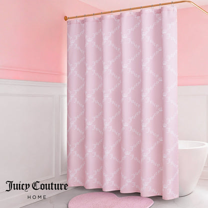A pink bathroom showcases the Shower Curtain and Hooks Set with a pale pink Juicy Couture logo pattern, paired with a white tub, white wainscoting, and a heart-shaped pink rug. The Juicy Couture Home logo appears in the bottom left corner.
