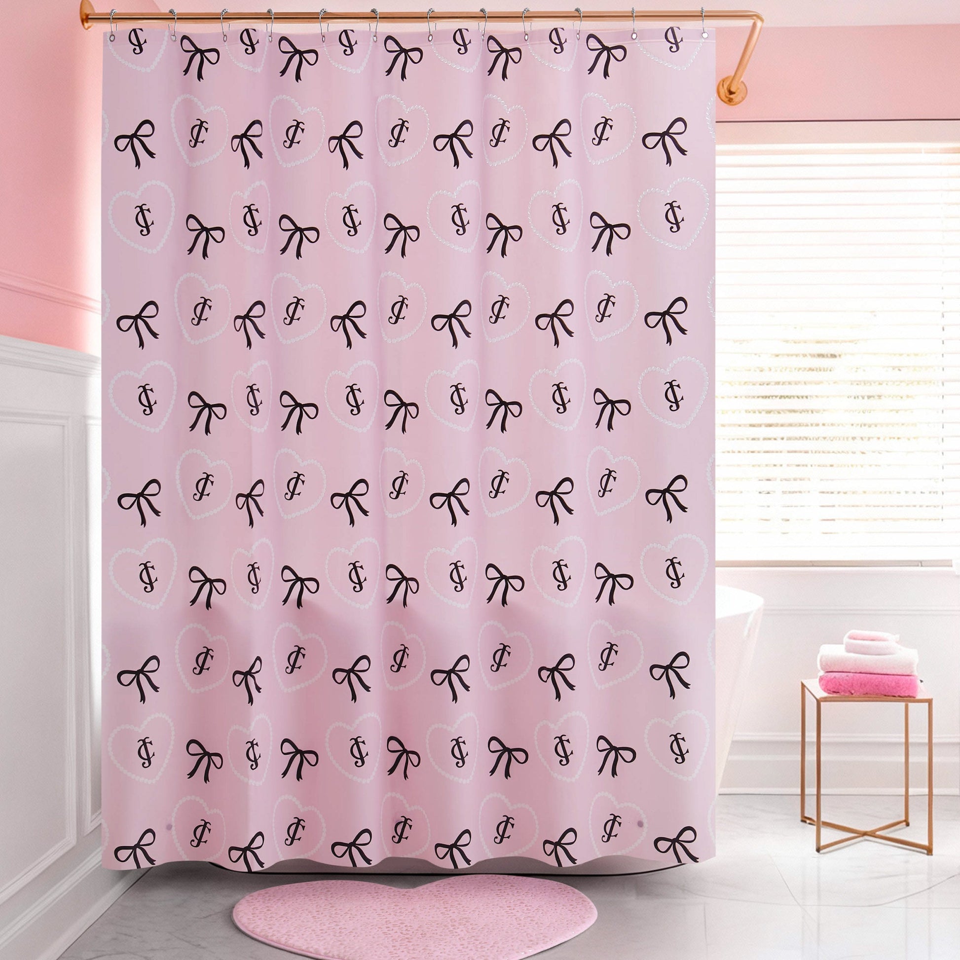 The PEVA Shower Curtain Liner features a pink design with black bows and cursive letters, hanging in a chic pink and white bathroom with a window, pink towels, and a coordinating rug. This waterproof liner adds stylish flair to your space.