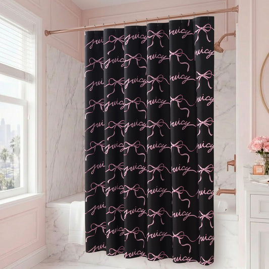 A bathroom with marble walls features the Sweet Bow Shower Curtain with PEVA Liner and Hooks 14-Piece Set, adorned with repeating pink bows and bold text, making it a striking statement piece. A window, a vase of pink flowers, and gold and white accents complete the chic bath decor.