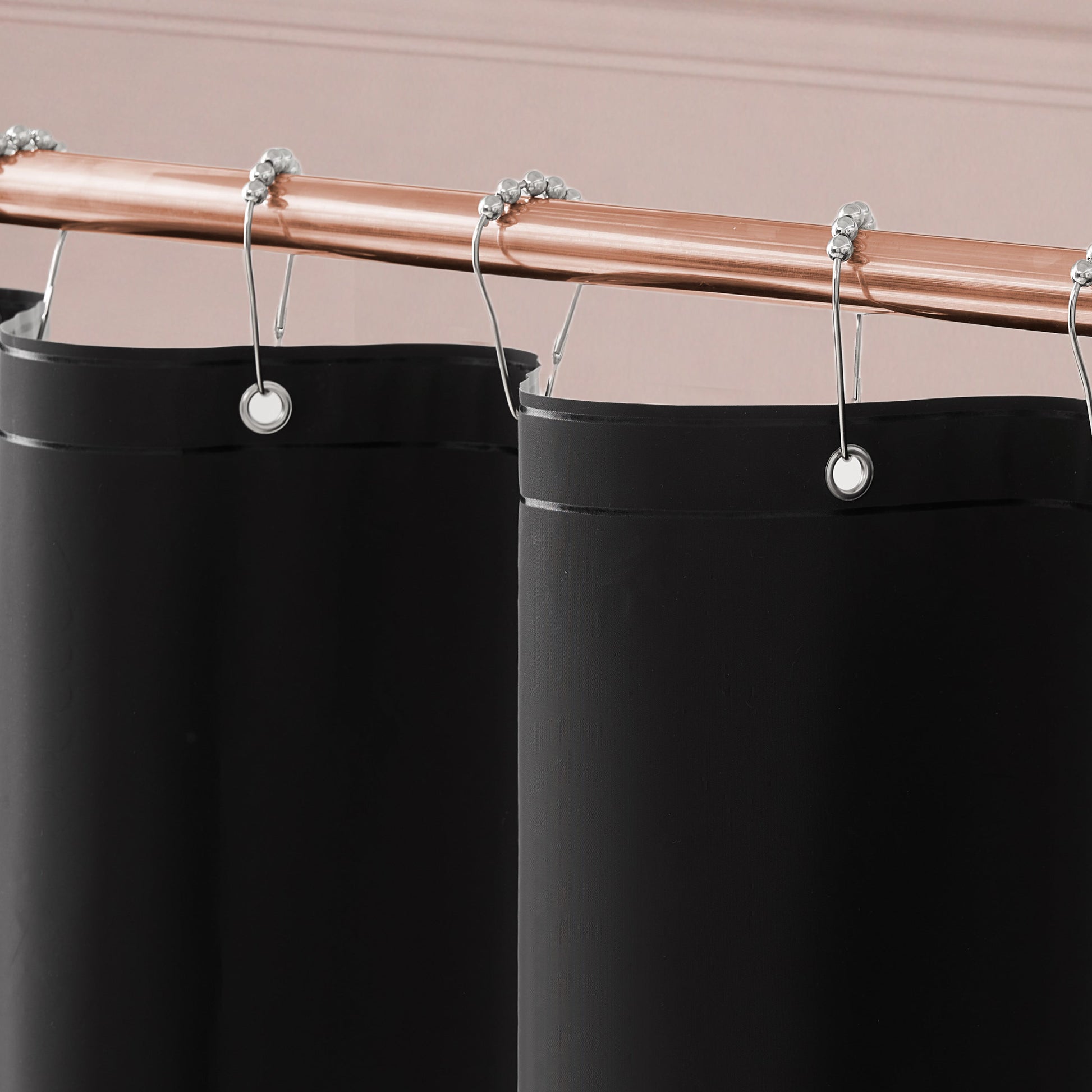 The Bow Leopard Shower Curtain with PEVA Liner and Hooks 14-Piece Set hanging from a copper-colored rod with silver curtain rings makes a bold statement in your bathroom decor, beautifully contrasting against the light pink wall.